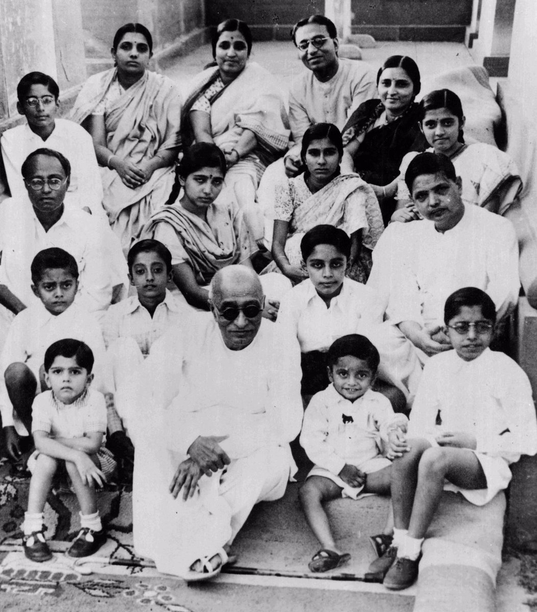 Large family group on a verandah with C. Rajagopalachari seated at the centre.
